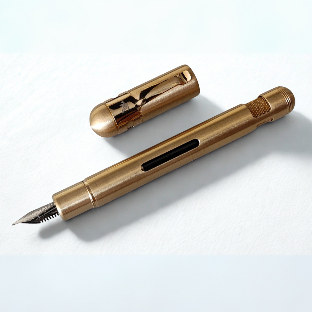 raw brass fountain pen on a white background