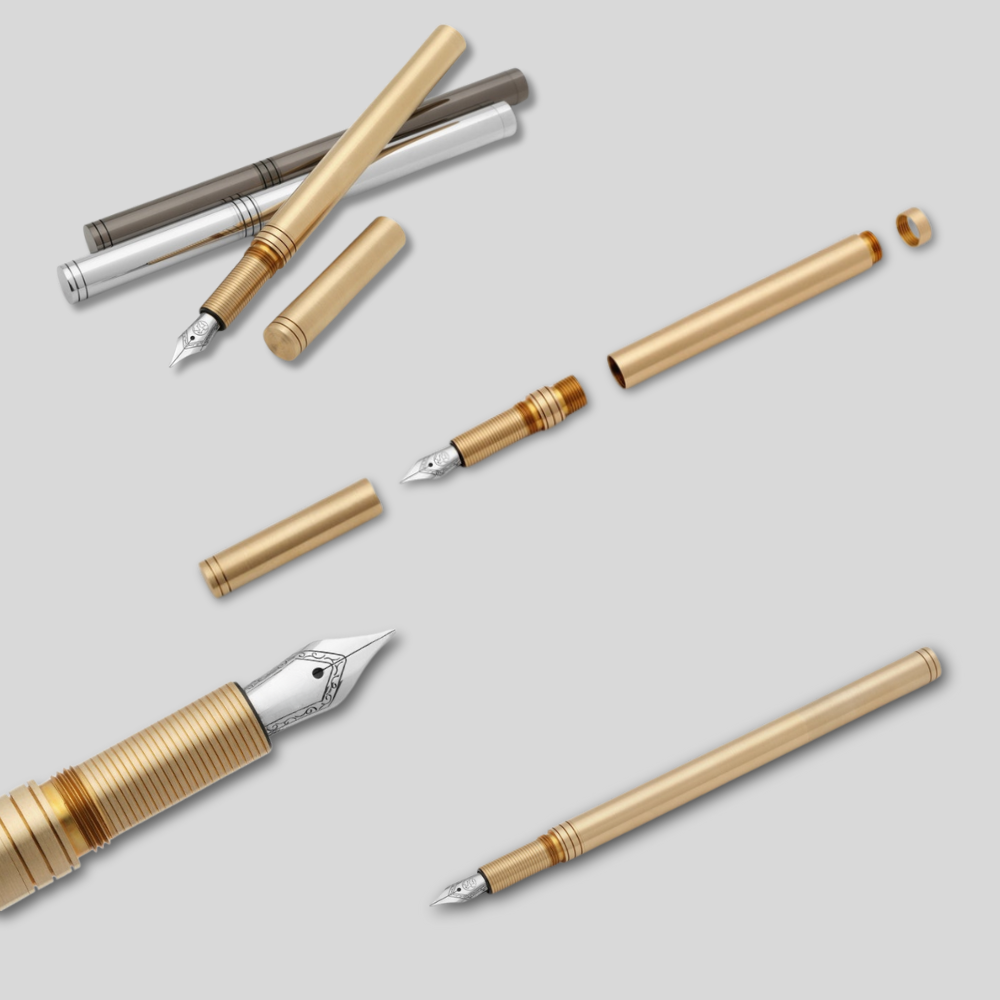 Collection of fountain pen components on a light gray background
