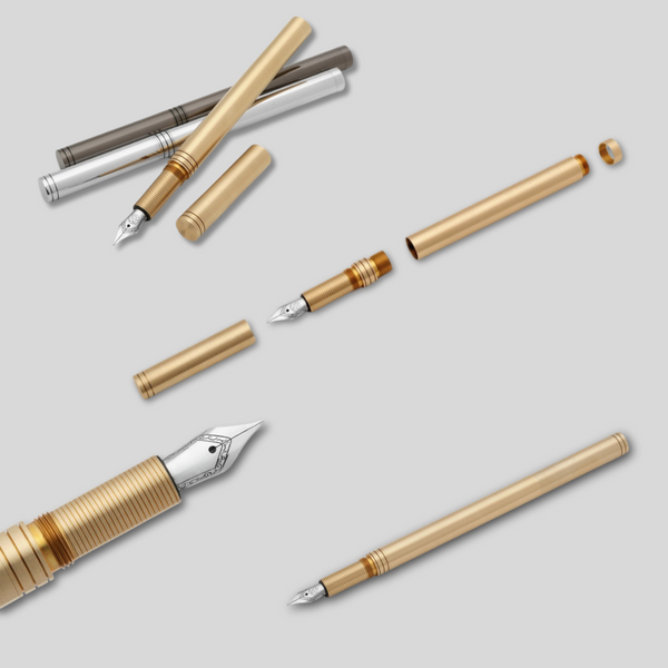 Collection of fountain pen components on a light gray background