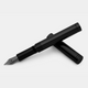 loclen tiny black fountain pen sitting on its cap